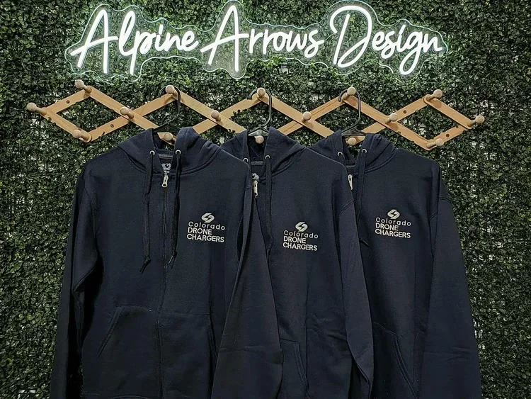 Matching zip-up hoodies with a left-chest embroidered company logo