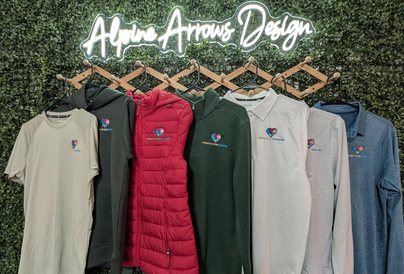 Custom embroidered company uniform program with a left-chest logo on tees, polos, quarter-zips and vests