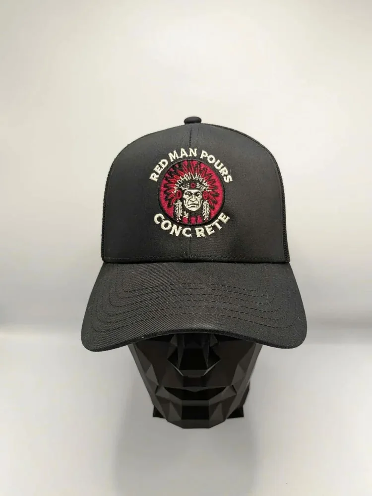 Black trucker cap with a full-color embroidered concrete company logo