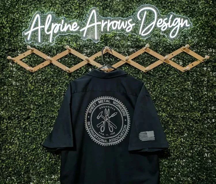 Navy work shirt with a tone-on-tone embroidered emblem across the back